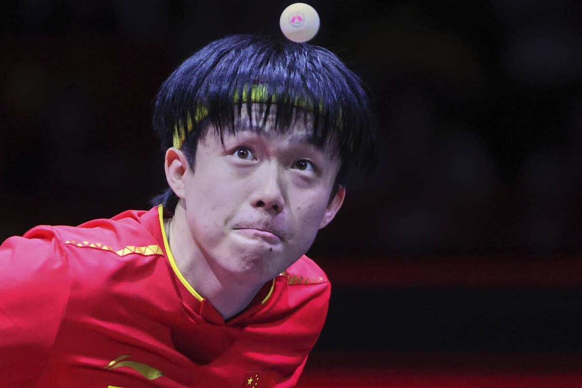 China's Wang Chuqin serves to Brazil's Hugo Calderano in the men's final match for the ITTF Wor ...