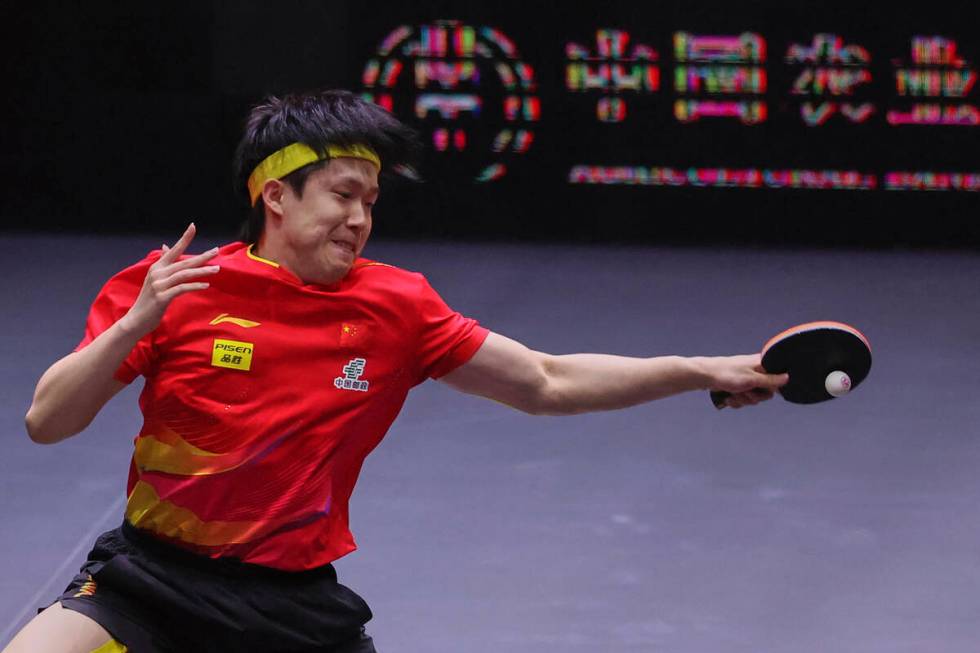 China's Wang Chuqin returns a shot from Brazil's Hugo Calderano in the men's final match for th ...