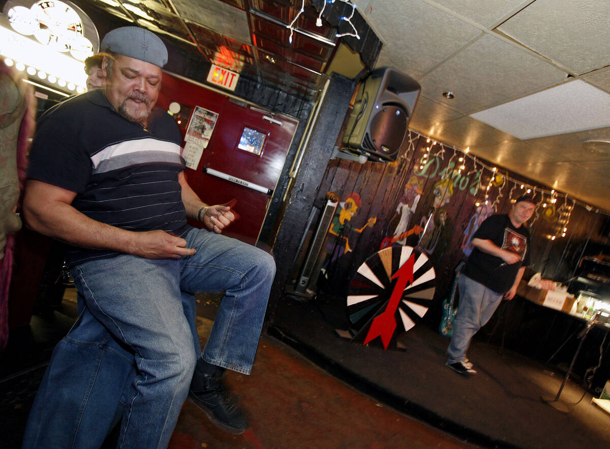 "Big" Frank Washington, left, rocks out while Tim Wallace, right, sings during karaoke at Dino' ...