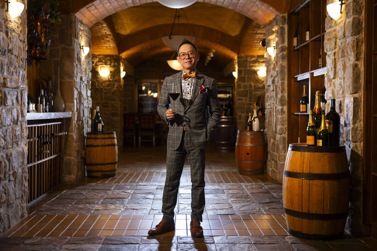 Hung Nguyen, wine cellar manager at The Wine Cellar Tasting Room at the Rio, poses for a portra ...