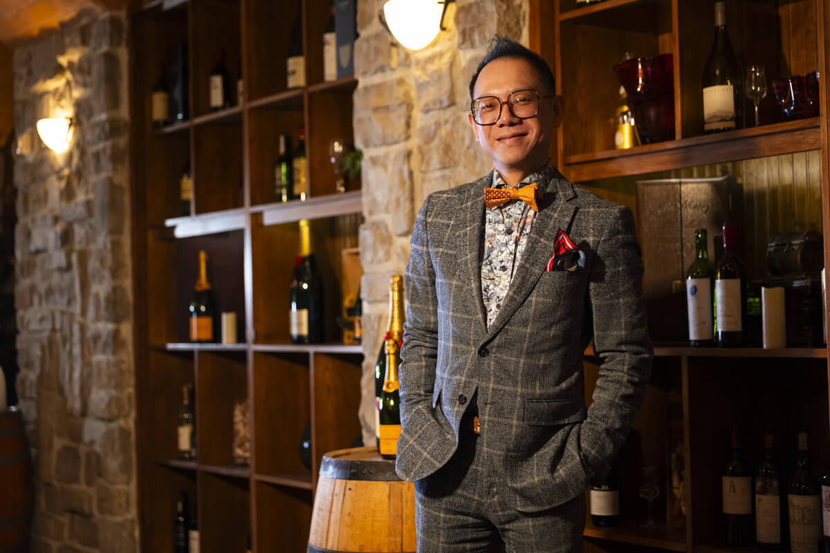 Hung Nguyen, wine cellar manager at The Wine Cellar Tasting Room at the Rio, poses for a portra ...