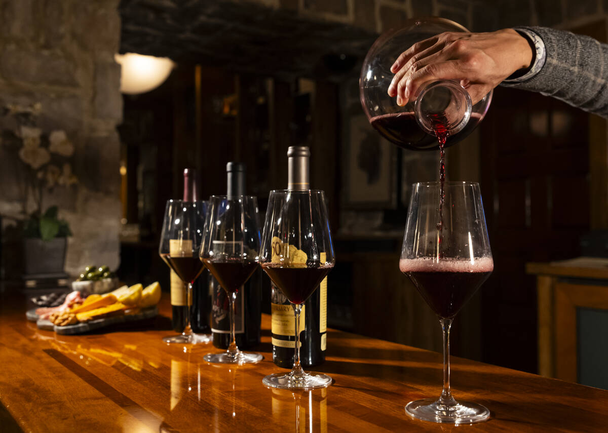 Hung Nguyen, wine cellar manager at The Wine Cellar Tasting Room at the Rio, pours wine on Wedn ...