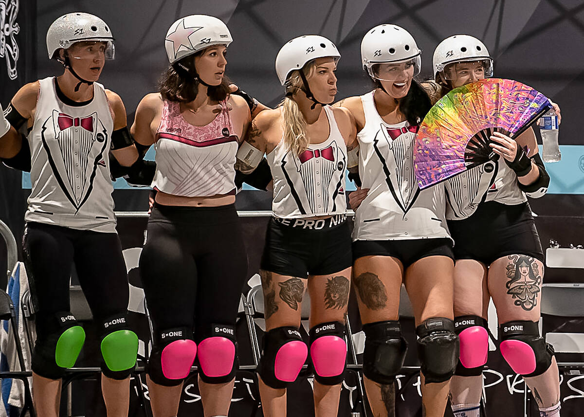 A roller derby squad sizes up the competition during a match at RollerCon, which marks its 20th ...