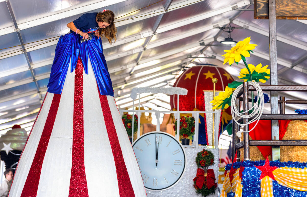 Gabriella Orr works atop the America Standing Tall float as final preparations continue for the ...