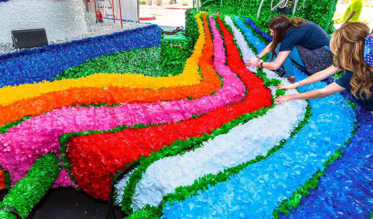 Robbi Butchko and Gabriella Orr work to complete the Wicked float for the 31st annual Summerlin ...
