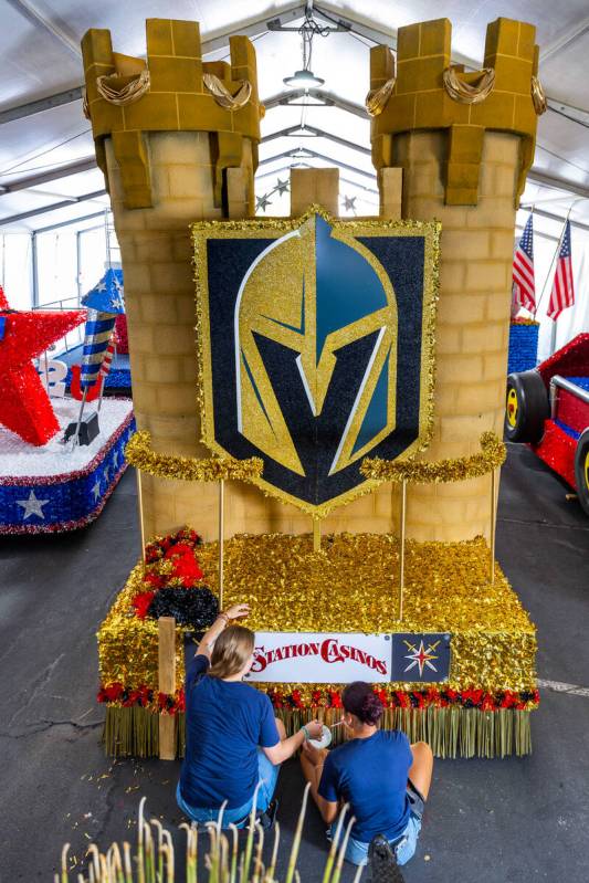 Jordyn Doyle and Elizabeth Engle finish painting a sign on the VGK float for the 31st annual Su ...