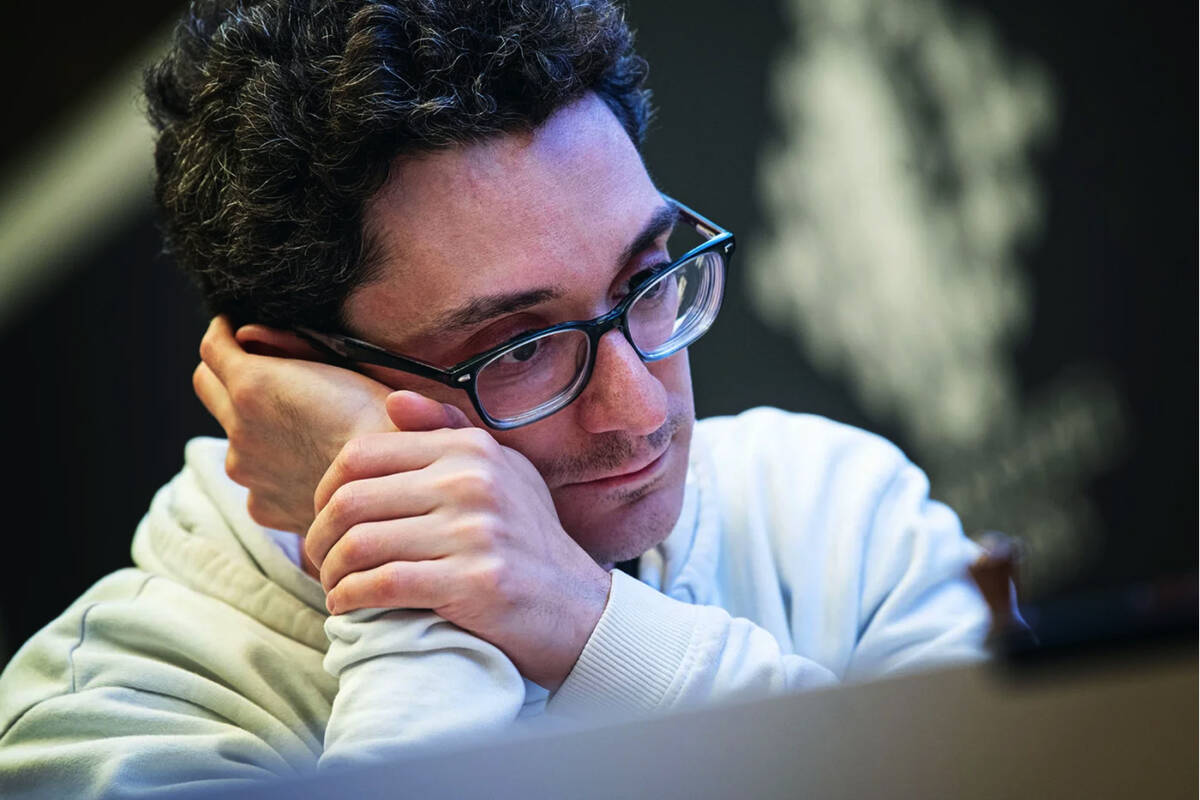 Four-time U.S. chess champion Fabiano Caruana surveys the board during a match at the Grenke Fr ...