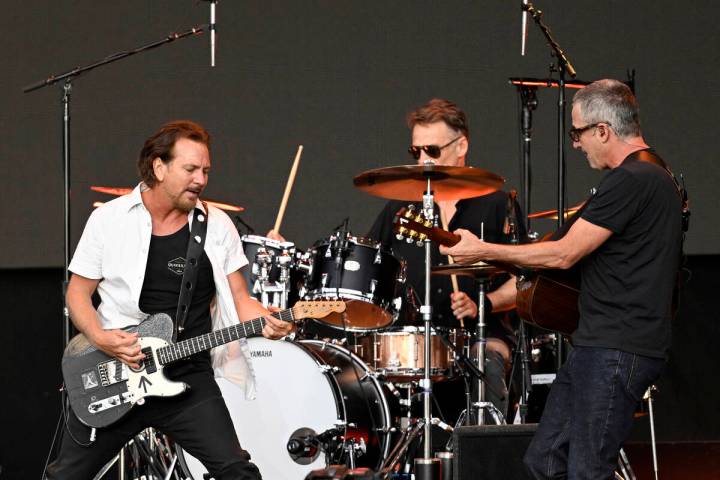 From left, Eddie Vedder, Matt Cameron and Stone Gossard of Pearl Jam perform on stage as Americ ...