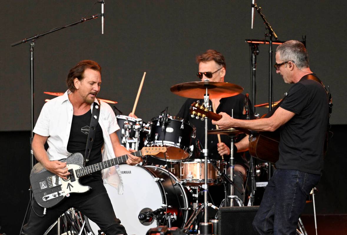 From left, Eddie Vedder, Matt Cameron and Stone Gossard of Pearl Jam perform on stage as Americ ...
