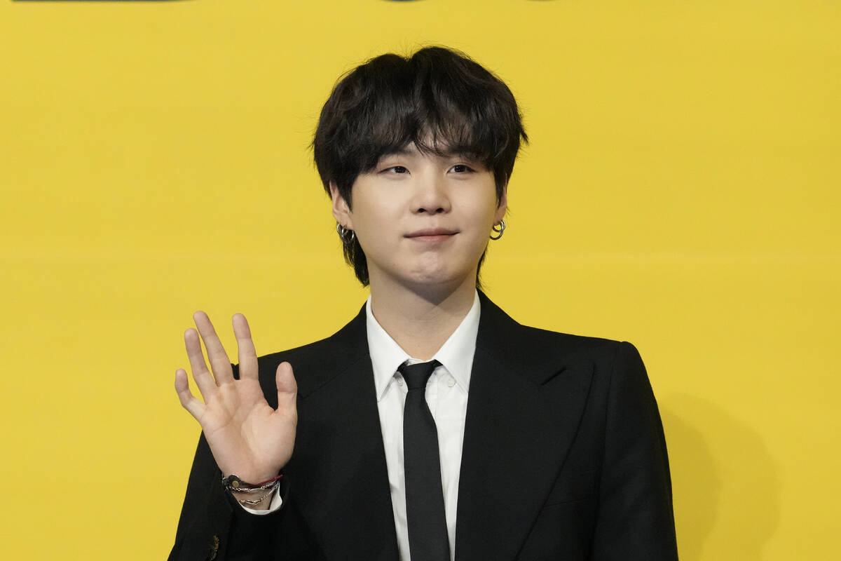 Suga, a member of South Korean K-pop band BTS, poses for photographers ahead of a press confere ...