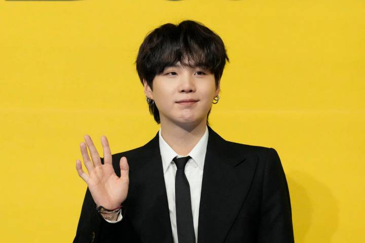 Suga, a member of South Korean K-pop band BTS, poses for photographers ahead of a press confere ...