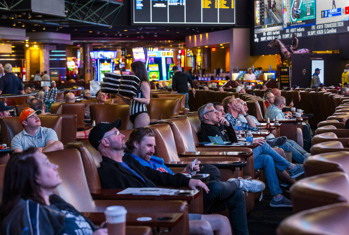 Bettors relax in the comfy loungers as they take in the early action during first day of NCAA T ...