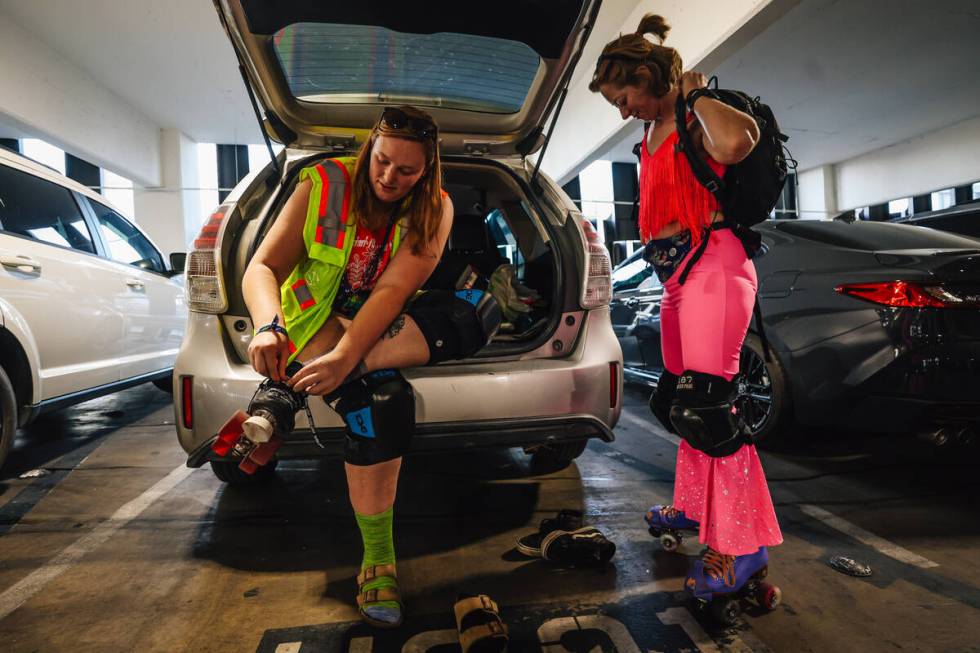 Amber Donat, left, gets her skates on as Laura Anderson puts her backpack on before a sunset sk ...