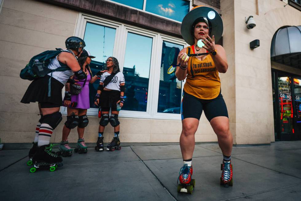 Sophia Macik juggles with skates on in front of the Downtown Grand during RollerCon Wednesday, ...