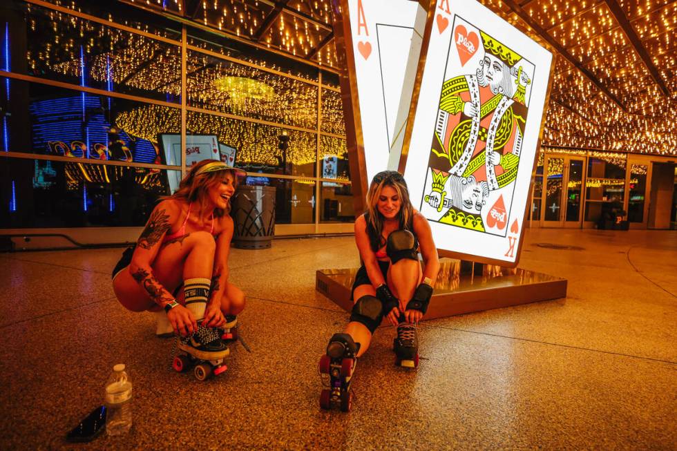 Kadee Strait, left, laces up her skates as Shay Rae does to the same outside of Plaza during Ro ...