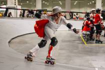 A roller derby participant dressed as Elvis laps the rink during RollerCon at the World Market ...