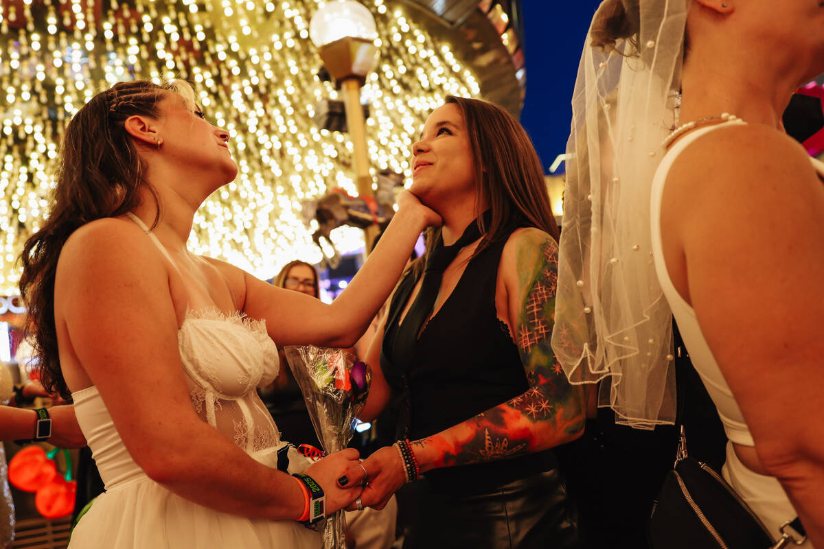 Shay Rae, left, and her derby wedding groom, Kayla Wysner, recite their vows during the RollerC ...