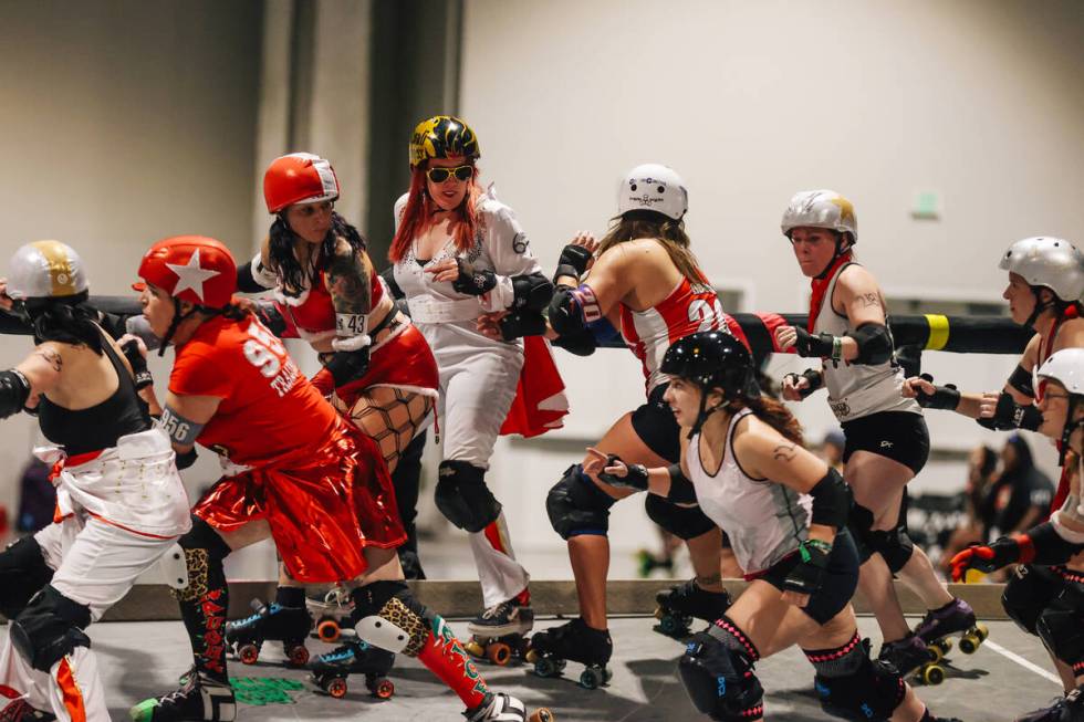 Team Elvis faces off against Team Santa in a roller derby during RollerCon at the World Market ...