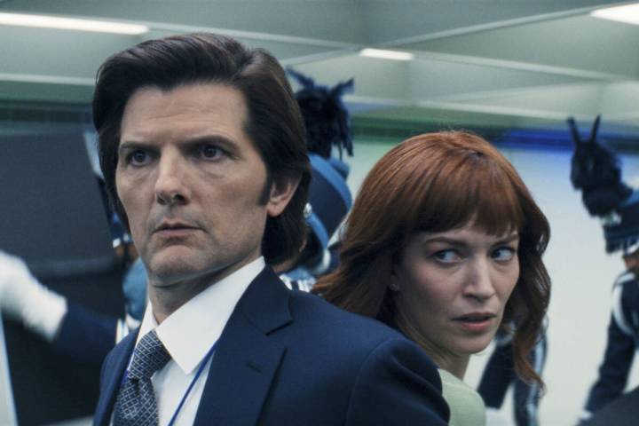 This image released by Apple TV+. shows Adam Scott, left, and Britt Lower in a scene from &quot ...