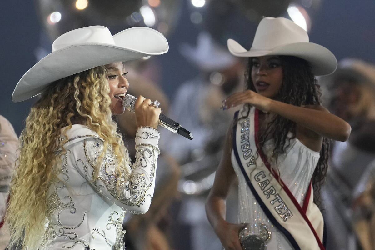 Beyoncé, left, performs alongside her daughter, Blue Ivy, right, during halftime of an NFL ...