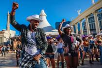 Fans dance to the music during a line dance to Beyonce’s “Texas Hold ‘Em” in front of C ...