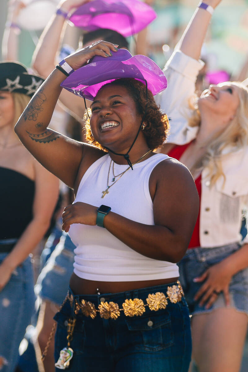 Fans dance to the music during a line dance to Beyonce’s “Texas Hold ‘Em&# ...