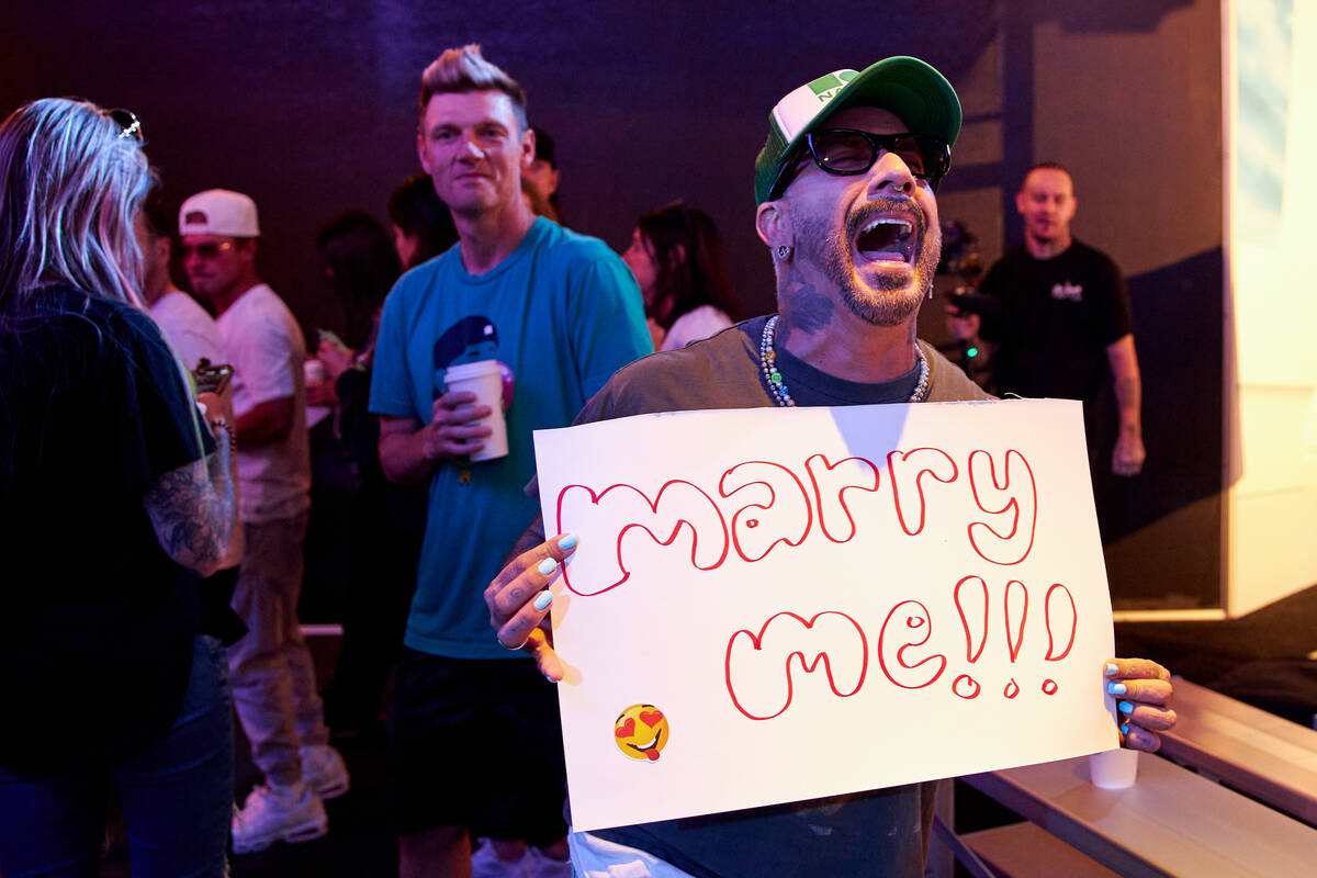 AJ McLean holds up a sign at the Backstreet Boys Terminal, a new immersive fan experience pop-u ...