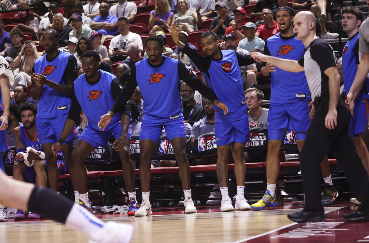 Oklahoma City Thunder players on the bench celebrate as the team leads against the Orlando Magi ...