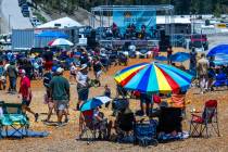People look for a good, shady spot as the Parametrics perform during the Music on the Mountain ...