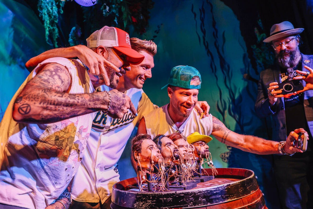 AJ McLean, from left, Nick Carter and Brian Littrell take photographs during the Backstreet Boy ...
