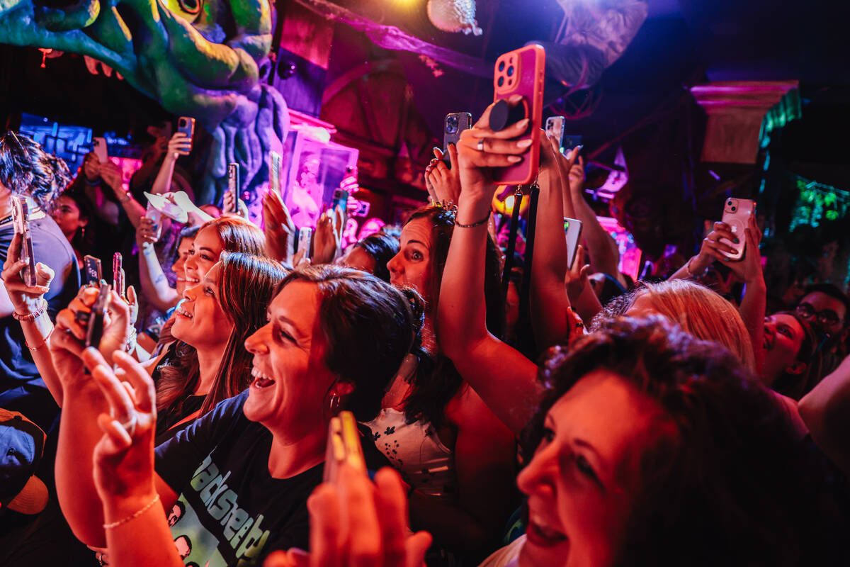Fans cheer and record during the Backstreet Boys’ shrunken head ceremony at Golden Tiki ...
