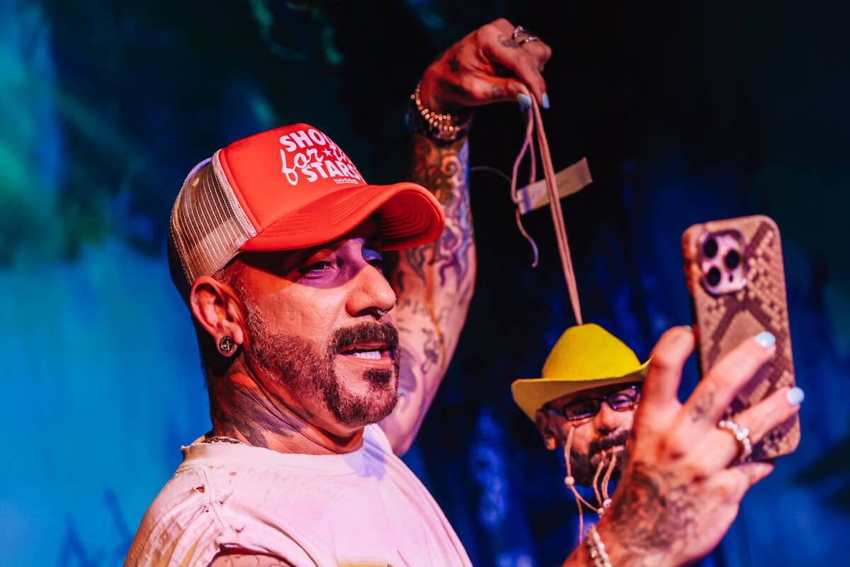 AJ McLean takes a photograph with his phone during the Backstreet Boys’ shrunken head ce ...
