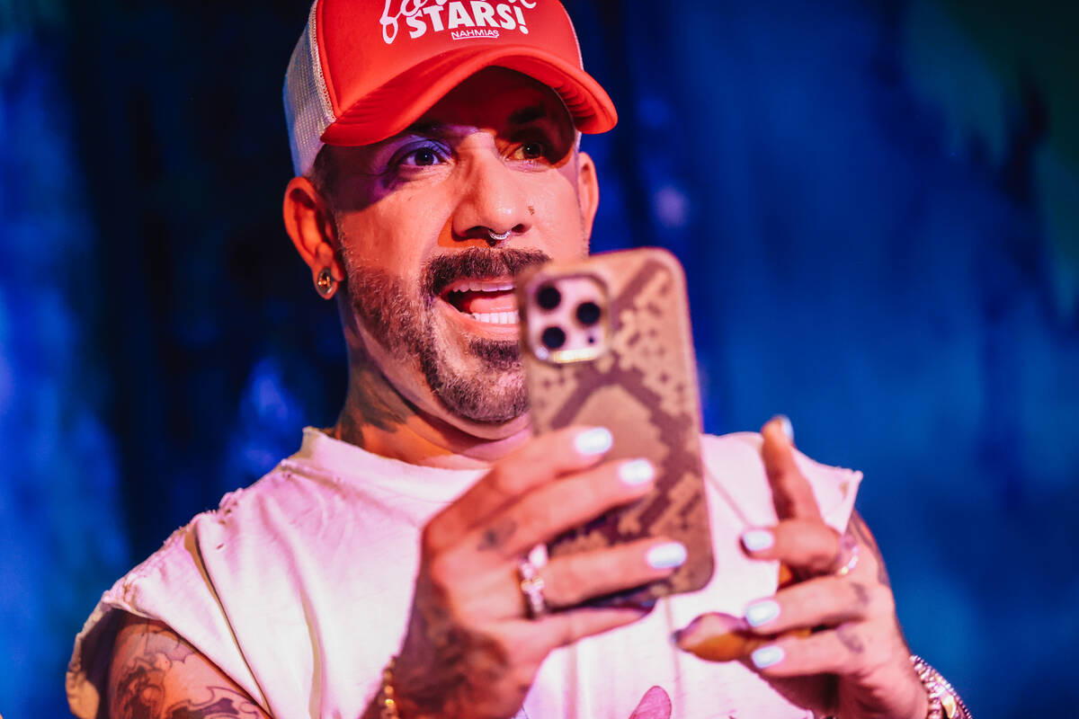 AJ McLean takes a photograph with his phone during the Backstreet Boys’ shrunken head ce ...