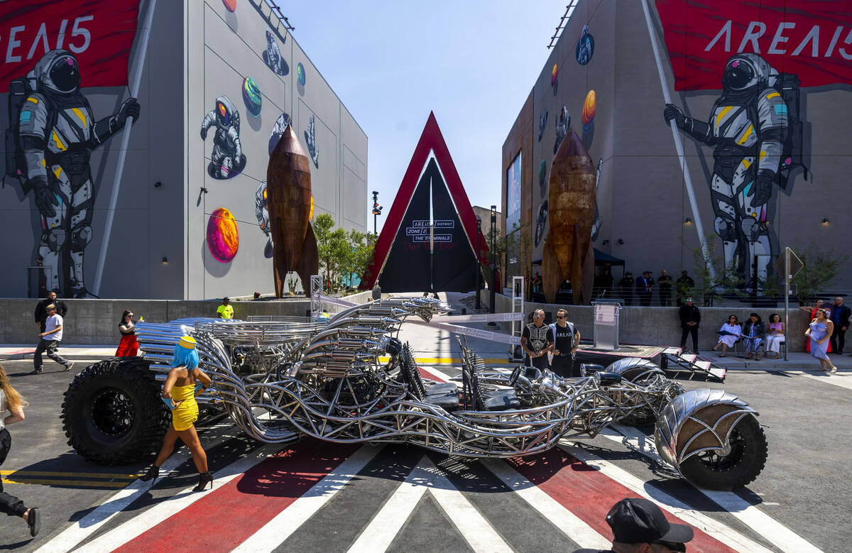 Artist Henry Chang stands with Winston Fisher, AREA15’s chief executive officer, after a ...