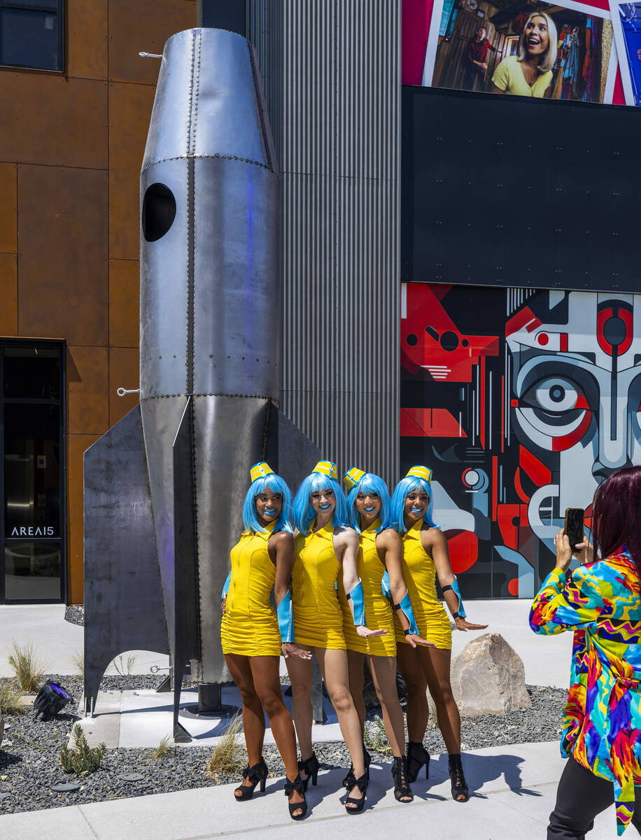 A group of "stewardess" performers pose near one of the new sculptures inside followi ...