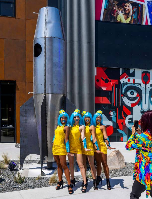 A group of "stewardess" performers pose near one of the new sculptures inside followi ...