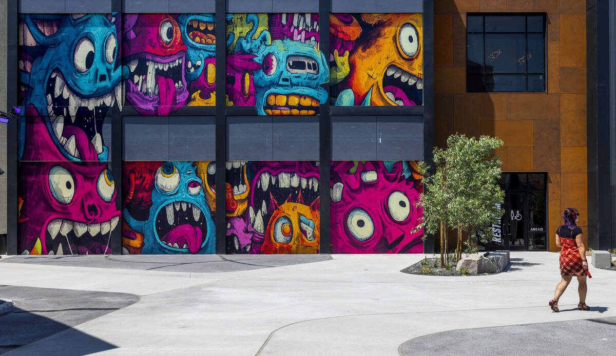 A visitor walks past one of the many new dynamic murals inside following the opening ceremony f ...