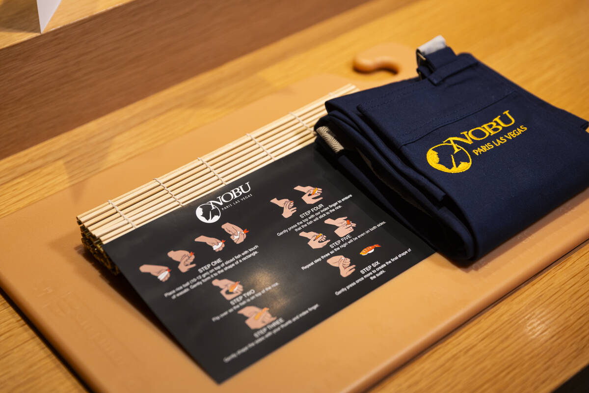 A place setting for the sushi-making class at Nobu, complete with a cutting board and apron, ar ...