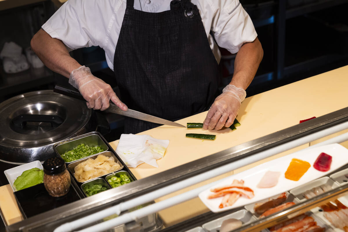 Tuan Pham, sous chef at Nobu, prepares a California roll for a sushi-making class demonstration ...