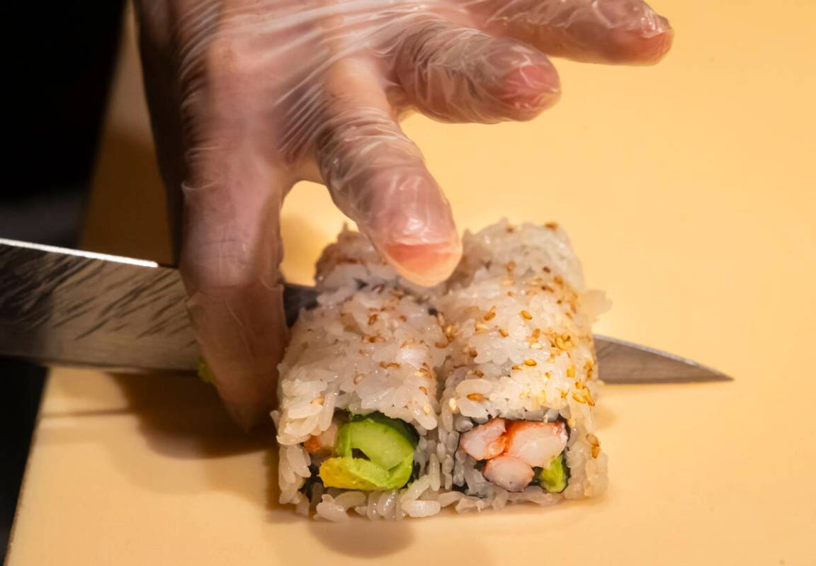 Tuan Pham, sous chef at Nobu, prepares a California roll for a sushi-making class demonstration ...