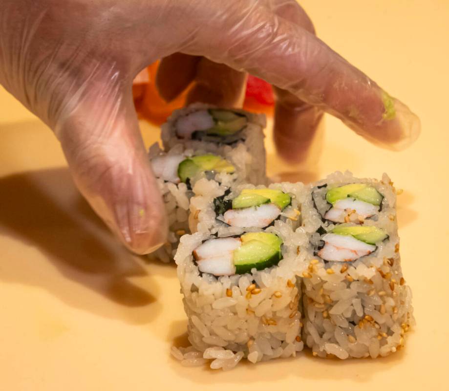Tuan Pham, sous chef at Nobu, prepares a California roll for a sushi-making class demonstration ...