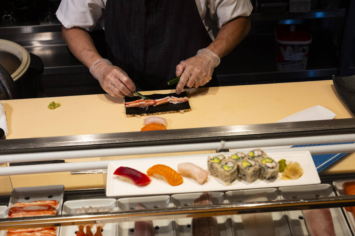 Tuan Pham, sous chef at Nobu, prepares a California roll for a sushi-making class demonstration ...