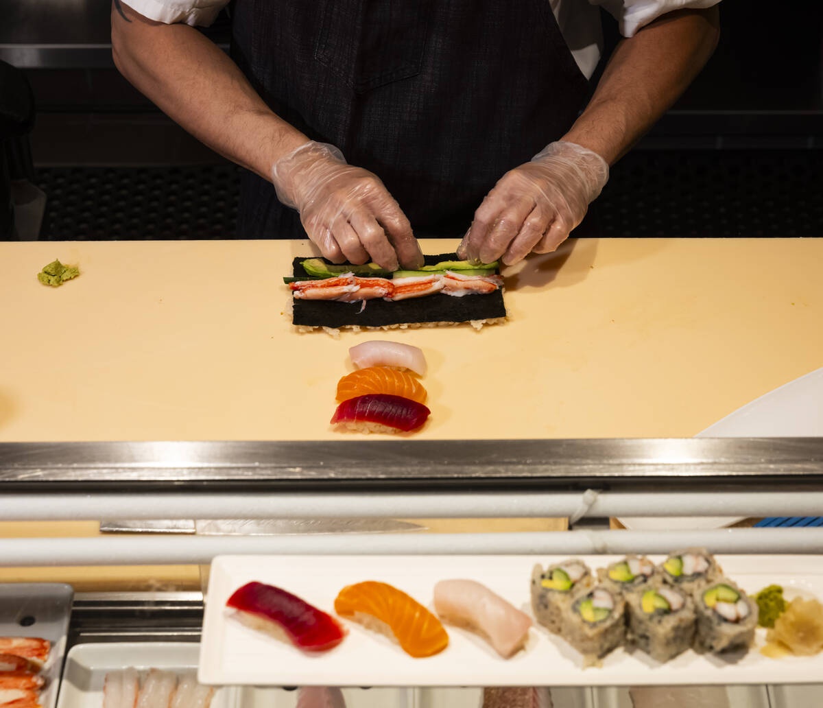Tuan Pham, sous chef at Nobu, prepares a California roll for a sushi-making class demonstration ...