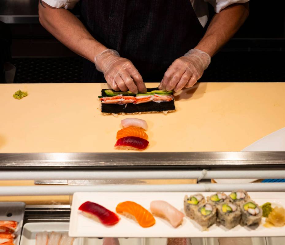 Tuan Pham, sous chef at Nobu, prepares a California roll for a sushi-making class demonstration ...