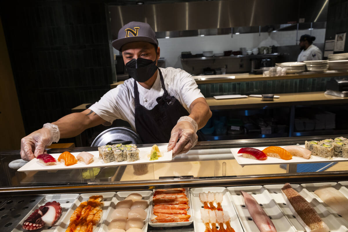 Tuan Pham, sous chef at Nobu, shows the finished plate for a sushi-making class demonstration a ...