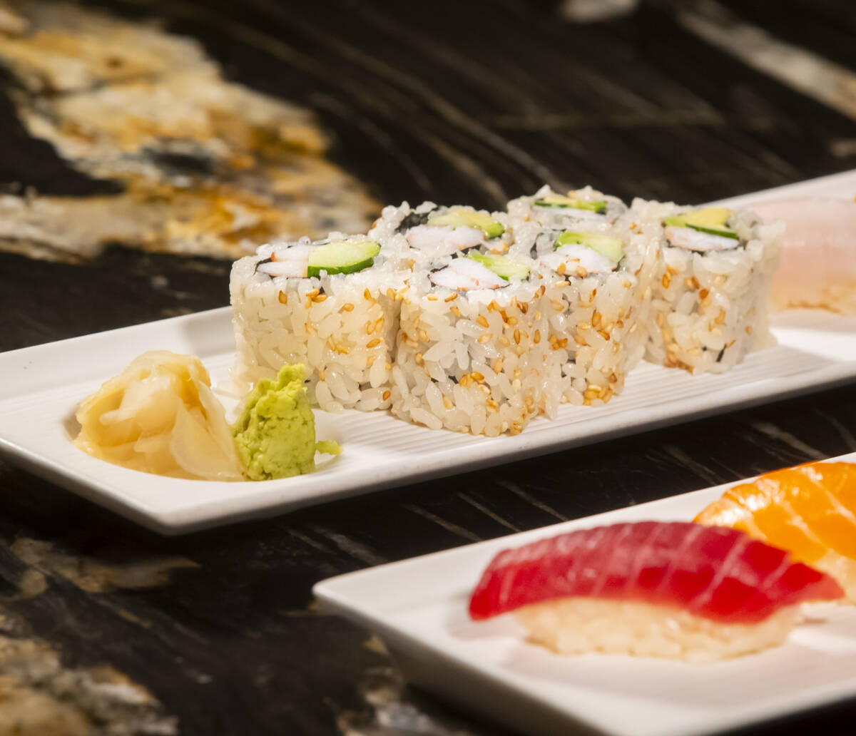 A California roll is seen alongside nigiri, prepared by Nobu sous chef Tuan Pham for a sushi-ma ...