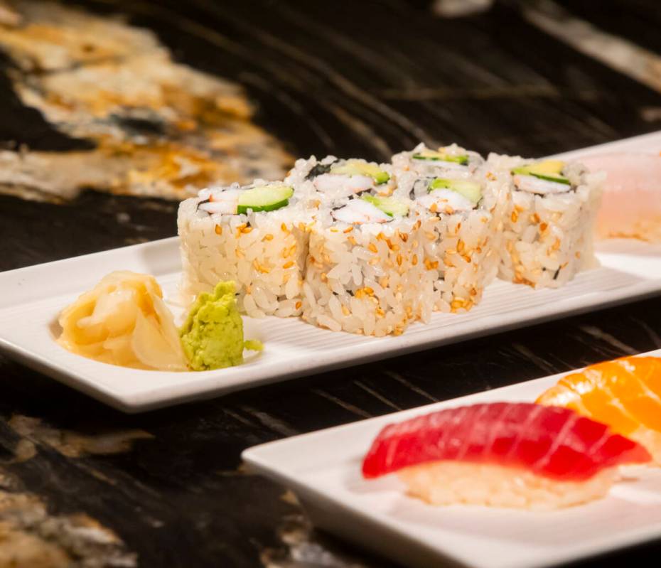 A California roll is seen alongside nigiri, prepared by Nobu sous chef Tuan Pham for a sushi-ma ...