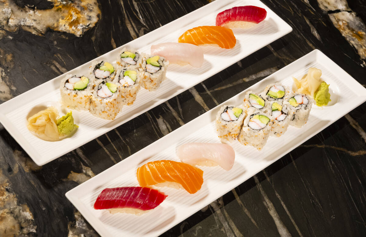 Tuna, salmon and yellowtail nigiri is seen alongside a California roll, prepared by Nobu sous c ...