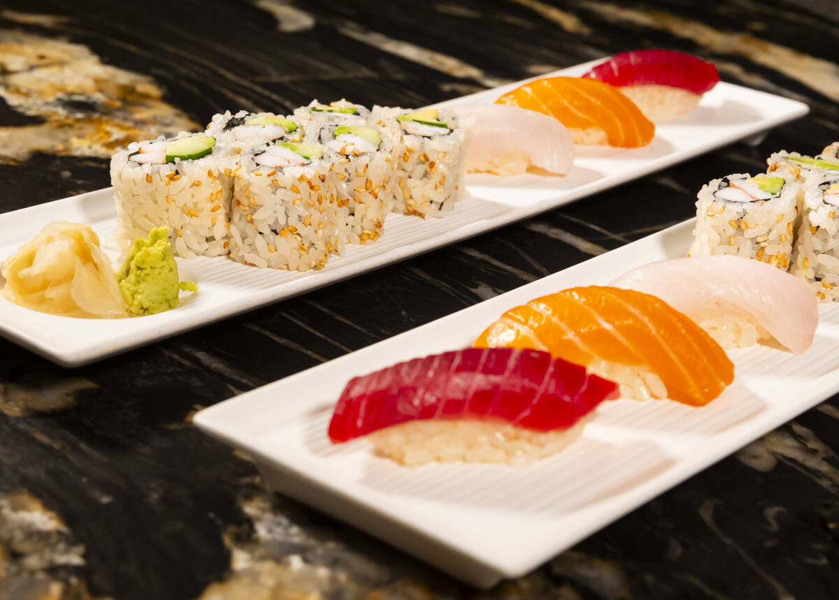 Tuna, salmon and yellowtail nigiri is seen alongside a California roll, prepared by Nobu sous c ...