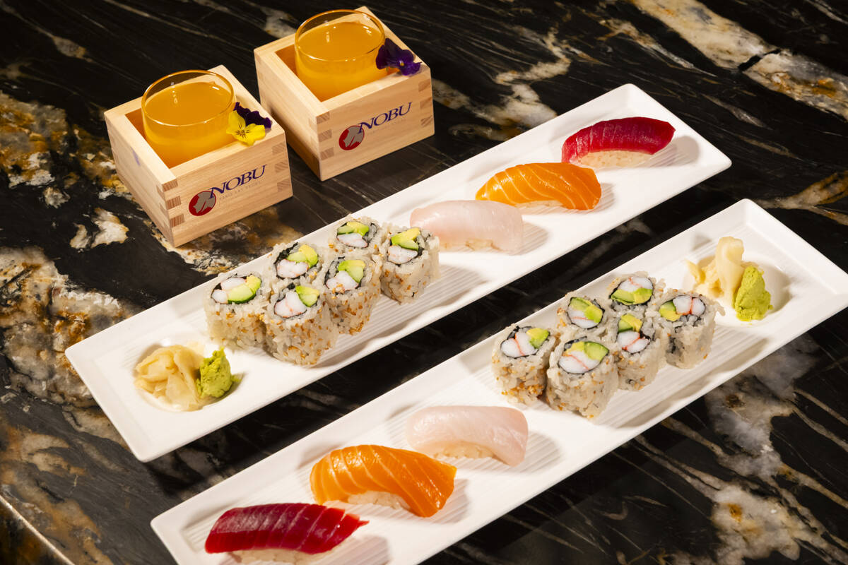 Tuna, salmon and yellowtail nigiri is seen alongside a California roll, prepared by Nobu sous c ...